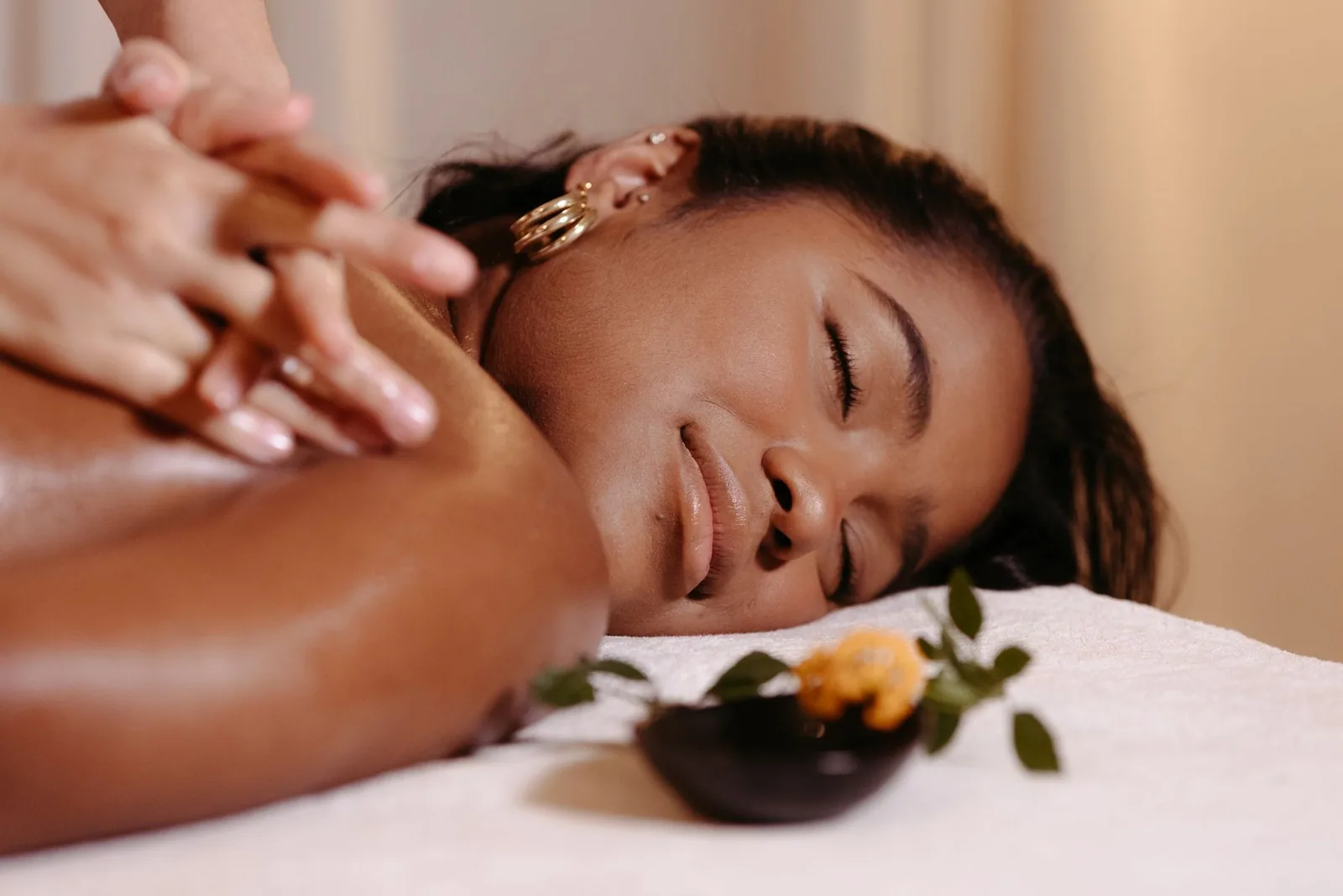 A calm shoulder massage in warm, natural light
